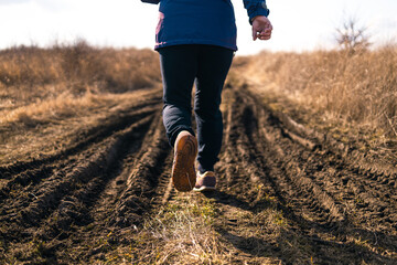 Woman feet in sport sneakers at the start. New start of the new year 2023, goals and plans for the...