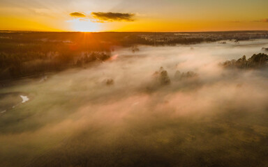 The landscape from the flight of the drone on the river valley is obscured by fog
