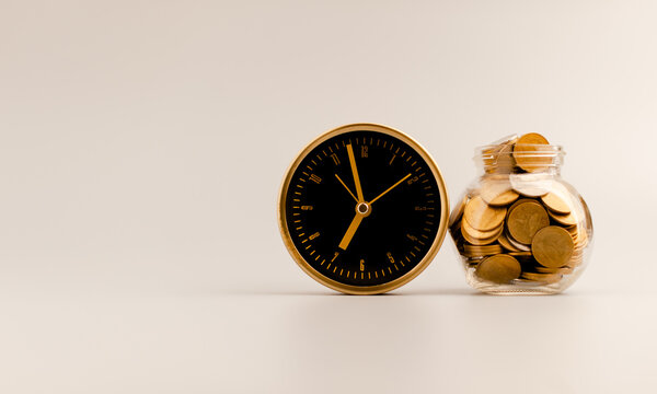 Golden Alarm Clock And Coin In Glass Bottle, Money Saving Idea.