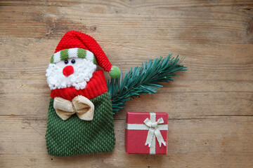 Father Christmas, Santa Claus decorative fabric figure on wooden background