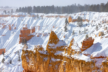 winter landscape of bryce canyon national park; freezing cold red rocks covered with snow, winter in the usa; landscape of mountains covered with snow, winter in the state of utah