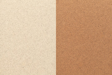 Texture of craft light beige and brown paper background, half two colors. Structure of vintage umber cardboard.