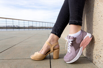 Woman in shoes and pink sneakers. Woman choosing comfortable sneakers