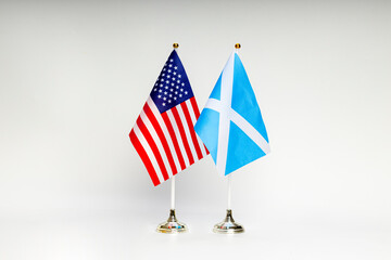 State flags of the USA and Scotland on a light background.