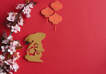 Fototapeta Chinese New Year, year of the rabbit. Year 2023 with golden rabbit and plum blossom fans. Copy space. obraz