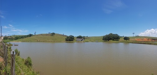 Little farmhouse house on a lake in the countryside. 