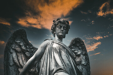 Fototapeta premium Sepulchral sculpture of an angel, judgment, in the monumental cemetery 