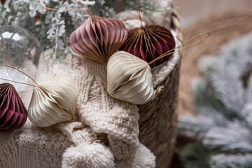 Stylish paper Christmas tree toys in Scandinavian style. Beige tones. View from above. Banner for design, web pages. The concept of a stylish new year and Christmas 2023.