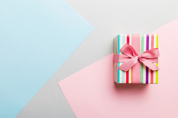 holiday paper present tied pink ribbon bow top view with copy space. Flat lay holiday background. Birthday or christmas present. Christmas gift box concept with copy space
