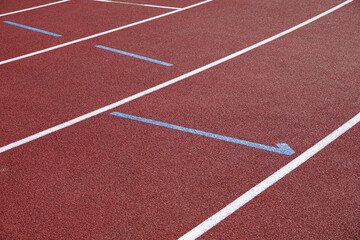 sports track running surface background. rubber ground of athletics track with painted lane markings