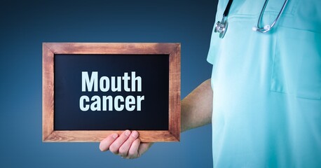 Mouth cancer (oral cancer). Doctor shows sign/board with wooden frame. Background blue