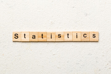 statistics word written on wood block. statistics text on cement table for your desing, concept