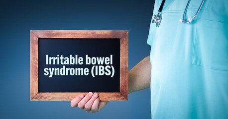 Irritable bowel syndrome (IBS). Doctor shows sign/board with wooden frame. Background blue