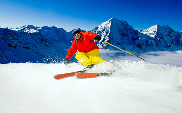 Man skiing in fresh powder snow at sunny day at the mountains, Italian Alps, Sulden