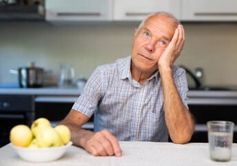 Thoughtful man sitting at table