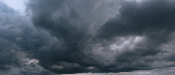The dark sky with heavy clouds converging and a violent storm before the rain.Bad or moody weather...