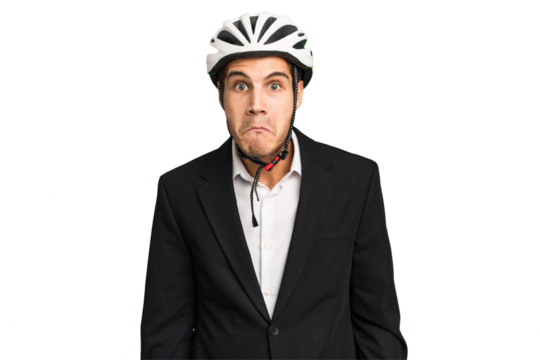 Business Caucasian man wearing a bike helmet isolated shrugs shoulders and open eyes confused.