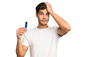 Young caucasian man holding an electronic cigarette isolated being shocked, she has remembered important meeting.