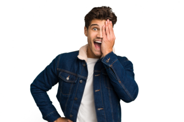 Young caucasian handsome man isolated having fun covering half of face with palm.