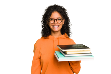 Young student woman holding a pile of books isolated happy, smiling and cheerful.