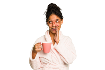 Young brazilian woman wearing a pajama holding a cup isolated is saying a secret hot braking news and looking aside