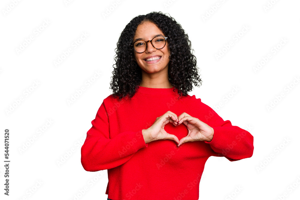 Wall mural young cute brazilian woman isolated smiling and showing a heart shape with hands.