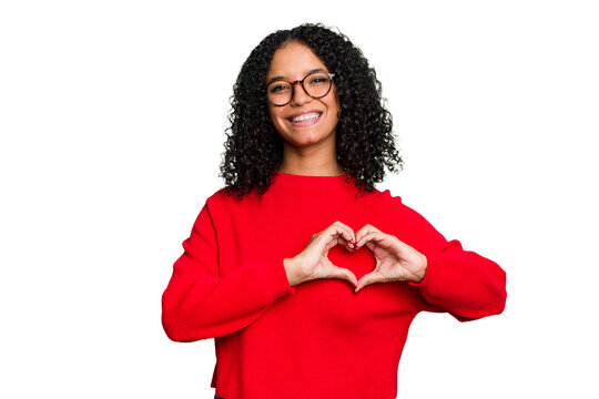 Young cute brazilian woman isolated smiling and showing a heart shape with hands. - Powered by Adobe