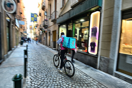 Deliveroo food delivery service runner at work downtown Turin Italy November 5 2022 deliberated motion blur