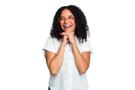 Young cute brazilian woman isolated keeps hands under chin, is looking happily aside.