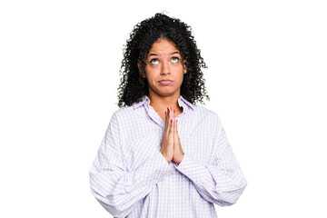 Young cute brazilian woman isolated holding hands in pray near mouth, feels confident.