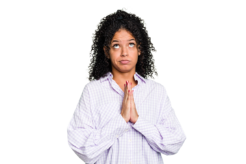 Young cute brazilian woman isolated holding hands in pray near mouth, feels confident.
