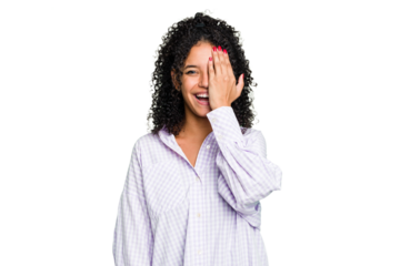 Young cute brazilian woman isolated having fun covering half of face with palm.