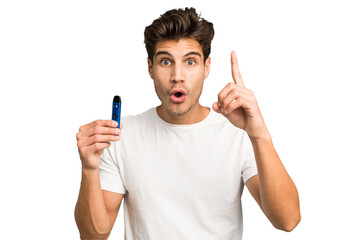 Young caucasian man holding an electronic cigarette isolated having an idea, inspiration concept.