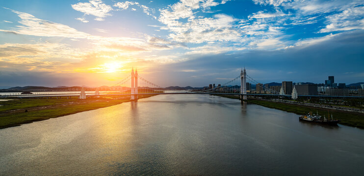 Beautiful bridge and river with city skylinen at sunset in Zhoushan, Zhejiang, China.