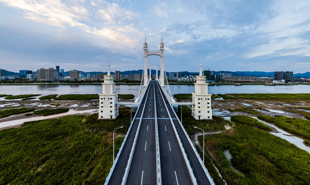 Beautiful bridge and river with city skylinen at sunset in Zhoushan, Zhejiang, China.