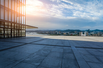 Empty square floors with city skyline at sunset in Zhoushan, Zhejiang, China.
