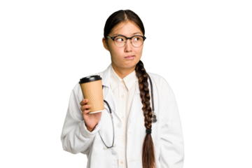 Young doctor asian woman holding a takeaway coffee isolated confused, feels doubtful and unsure.