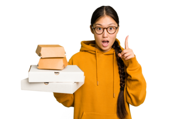 Young student asian woman holding a takeaway food isolated having an idea, inspiration concept.