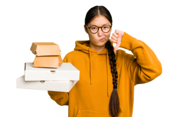 Young student asian woman holding a takeaway food isolated showing a dislike gesture, thumbs down. Disagreement concept.