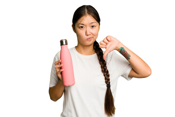 Young asian woman holding a pink thermo isolated showing a dislike gesture, thumbs down. Disagreement concept.
