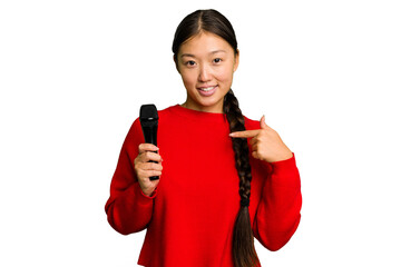 Naklejka premium Young Chinese singer woman isolated person pointing by hand to a shirt copy space, proud and confident