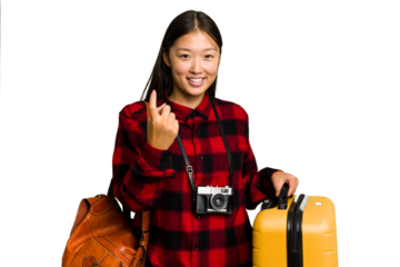 Traveler asian woman holding a suitcase isolated pointing with finger at you as if inviting come closer.