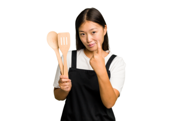 Young asian cook woman isolated pointing with finger at you as if inviting come closer.