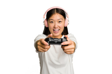 Young asian gamer woman playing with a game controller and headphones isolated