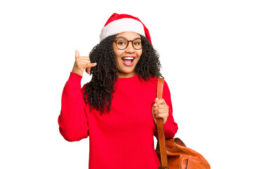Young african american student woman wearing a christmas hat isolated showing a mobile phone call...