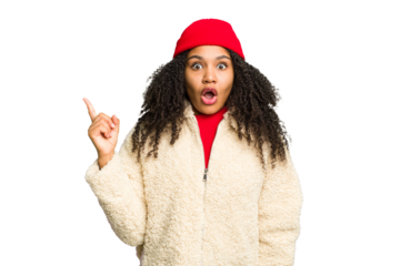 Young african american woman wearing winter clothes isolated pointing to the side