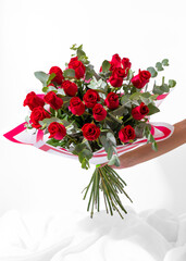 bouquet of red roses flowers isolated on white background with hand