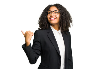 Young african american business woman isolated points with thumb finger away, laughing and carefree.