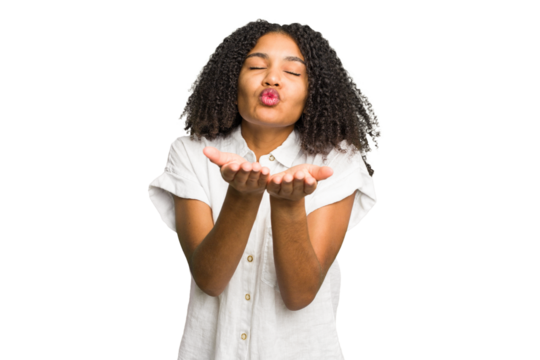 Young african american woman isolated folding lips and holding palms to send air kiss.