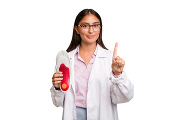 Young caucasian podiatrist woman isolated showing number one with finger.
